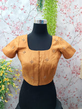 Light orange blouse with small golden as bhutas