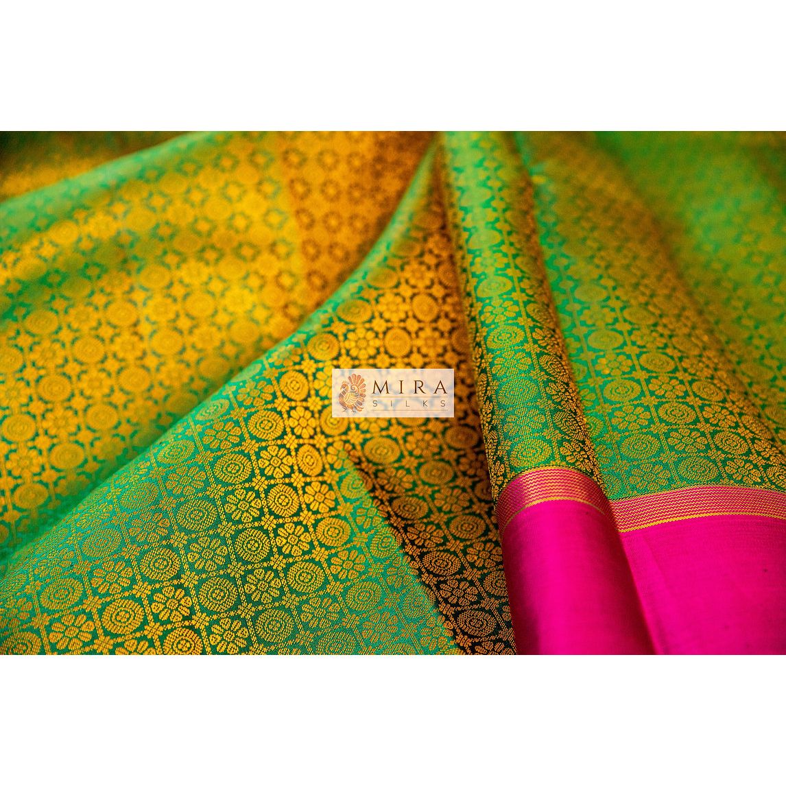 Emerald green with pink plain border kanjivaram sari