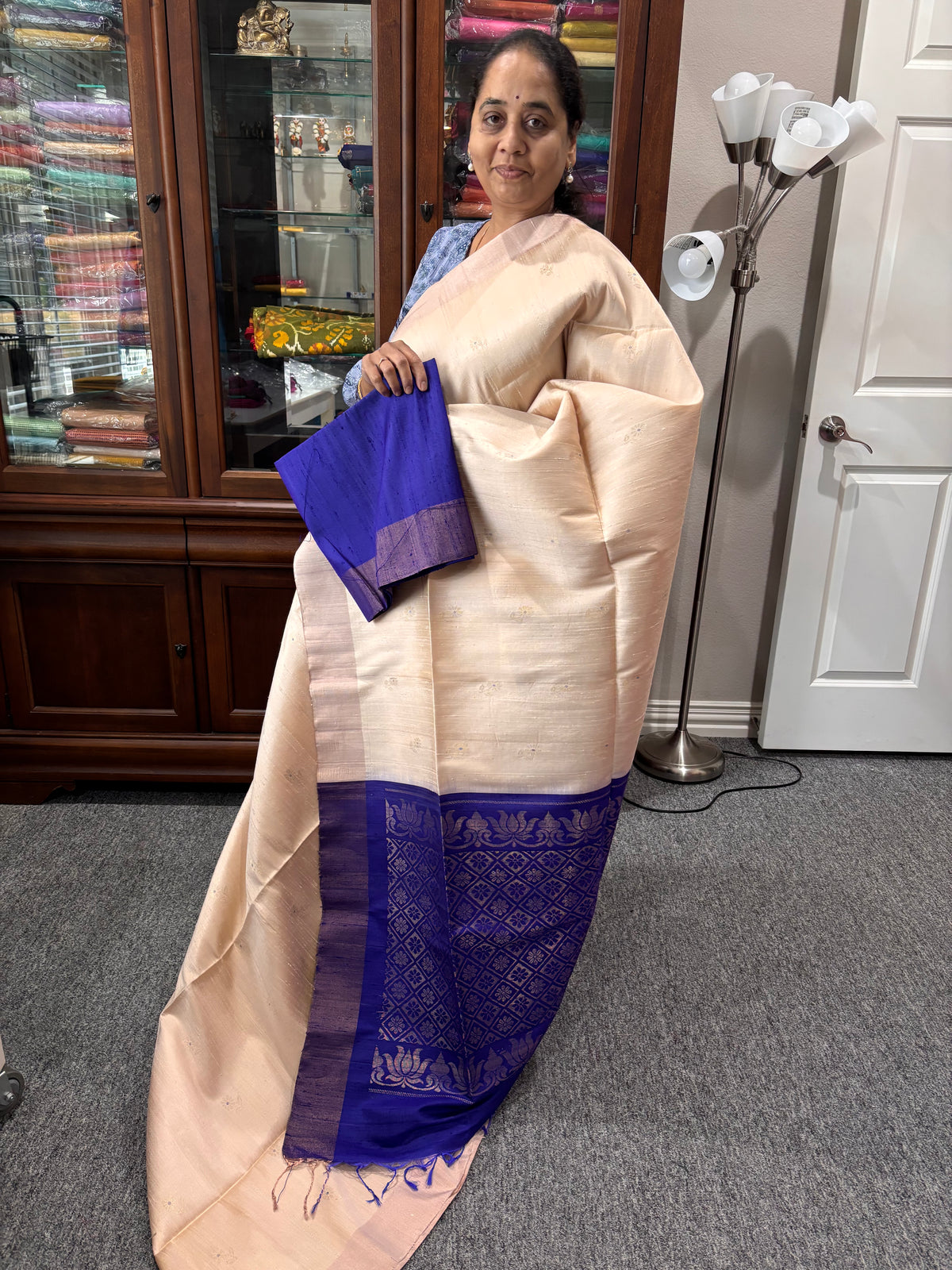 Beige color raw silk saree with royal blue pallu