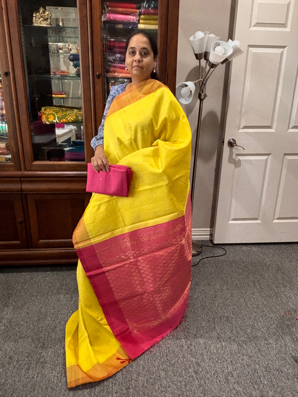 Yellow color raw silk saree with pink pallu