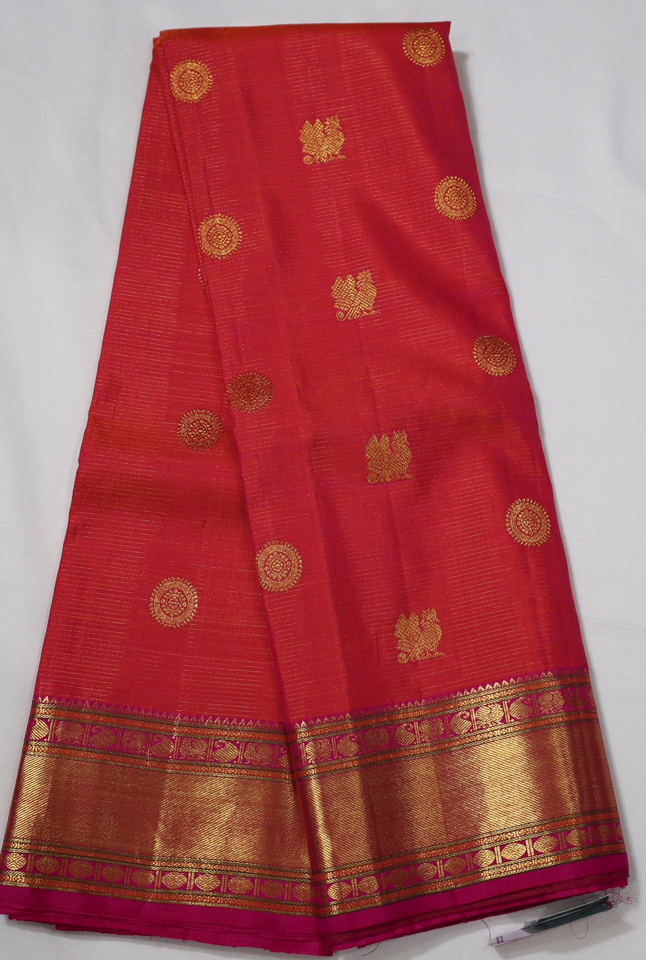 Orange Kanjivaram Saree with  Pink and golden Zari Border