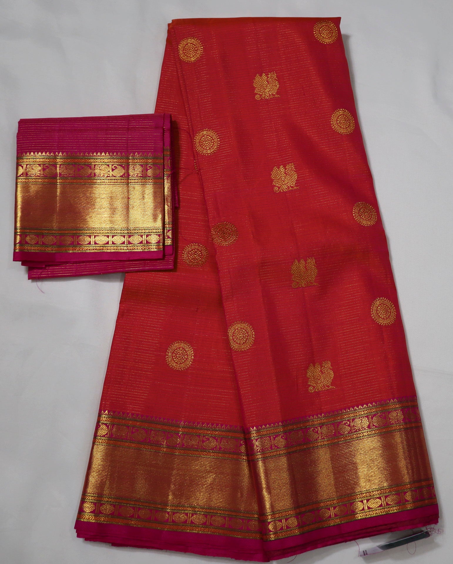 Orange Kanjivaram Saree with  Pink and golden Zari Border