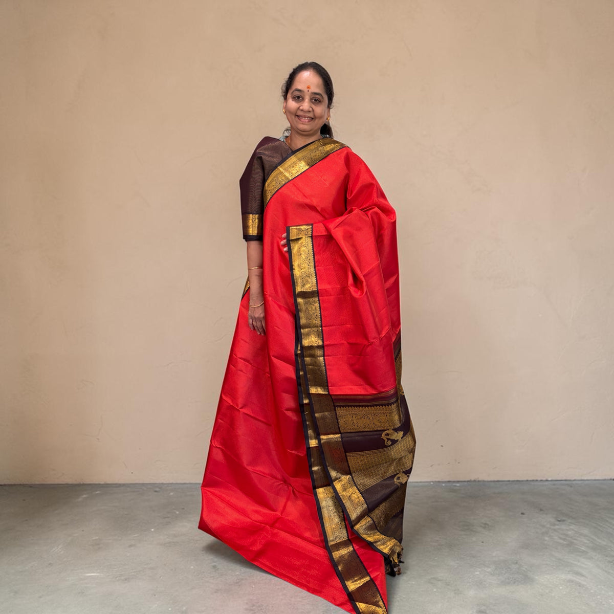 Orange Kanjivaram Saree with dark Brown and Golden Zari Border